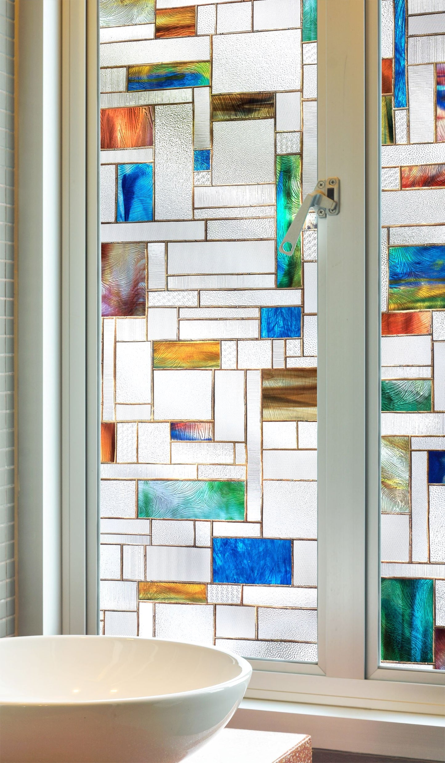 Modern square leaded glass window with pops of bright and saturated glass. The scale of this pattern lends itself well to a variety of window sizes and shapes. Really textured glass appearance.